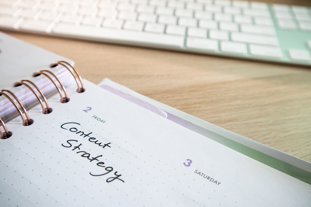Desk with a keyboard and a planner with the words Content Strategy on it